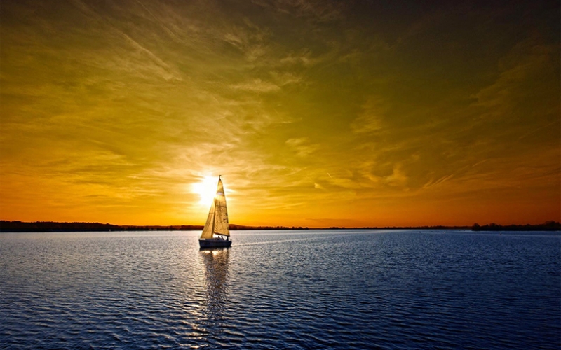 Sailing on the open sea at sunset